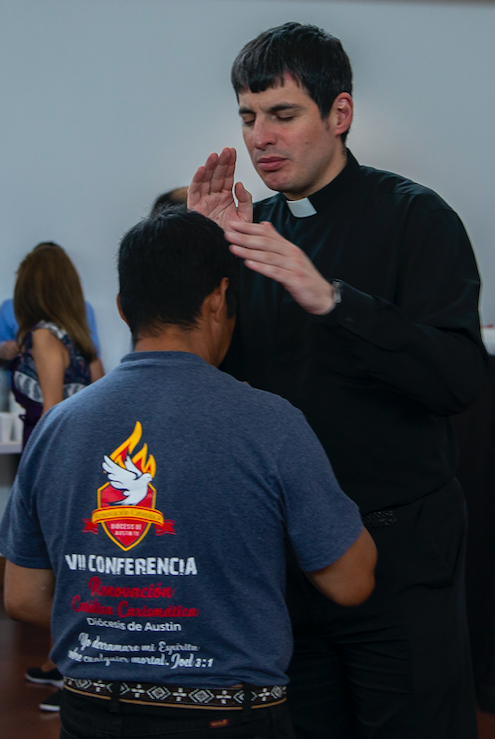 Fr. Garza blesses a parishioner.
