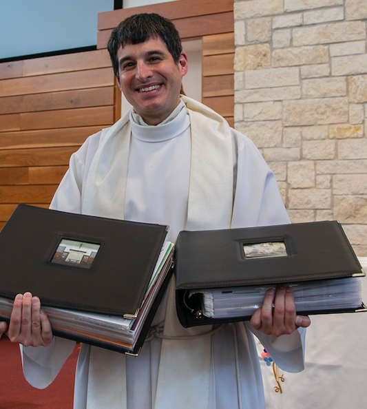 Father Garza also received scrapbooks full of photos of parishioners and events during his time at St. Martin.