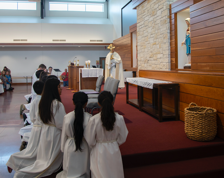 Fr. Garza blesses mass attendees with the monstance during Corpus Christi