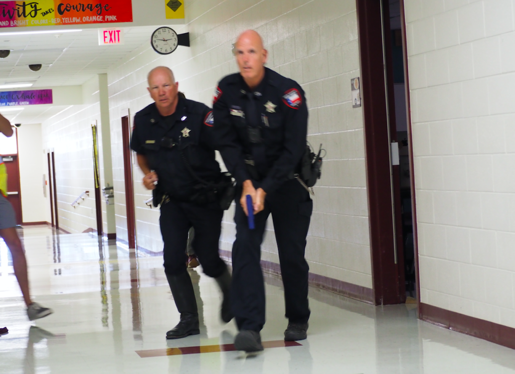 Pct. 4 Deputies Chick Williams and Jimmy Zuehlke enter a hallway looking for the suspect at the beginning of the exercise.
