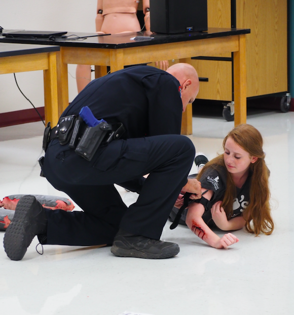 Pct. 4 Constable Jimmy Zuehlke attends a simulated wounded Emma Satine.