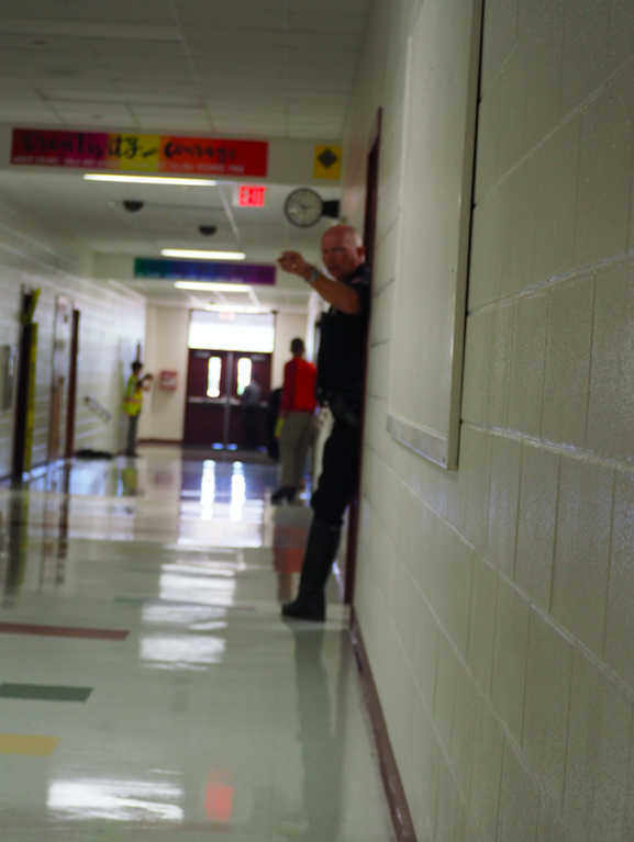 Pct. 4 Deputy Chick Williams signals the hallway is secure and its safe to bring in North Hays Fire/Rescue and EMS.