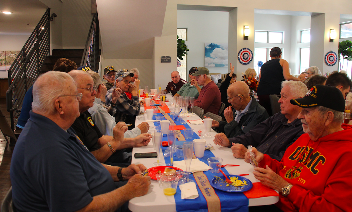At the head table, around 20 veterans gathered at a table near the front of the dining room to eat and share stories with fellow veterans.