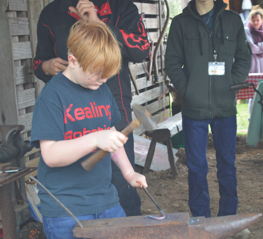 Owen Putnam tried his skill as a blacksmith.