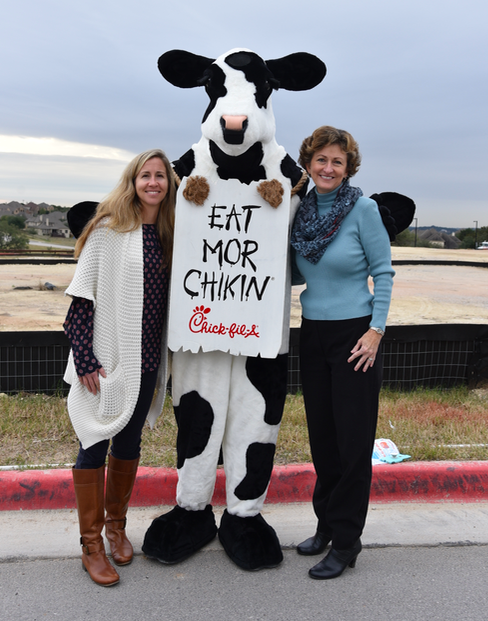 DSHS ROTC Club Sponsor Lauren Milner and DSISD Board Trustee Dr. Mary Jane Hetrick pose with the famous Chick-fil-A Cow.